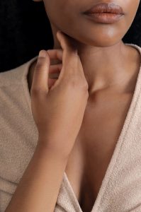Beautiful woman holding hand to face