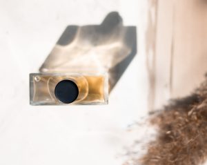 Bird's eye view of perfume bottle with black lid