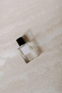 Nondescript bottle of perfume with natural background