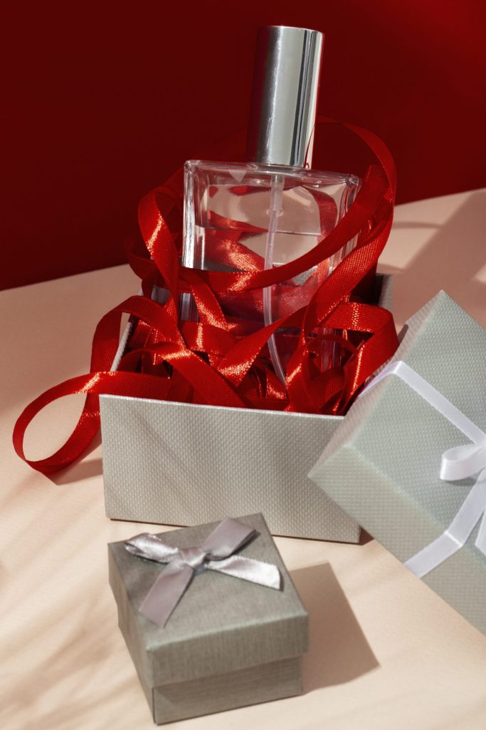 bottle of perfume in a gift box with red trimmings